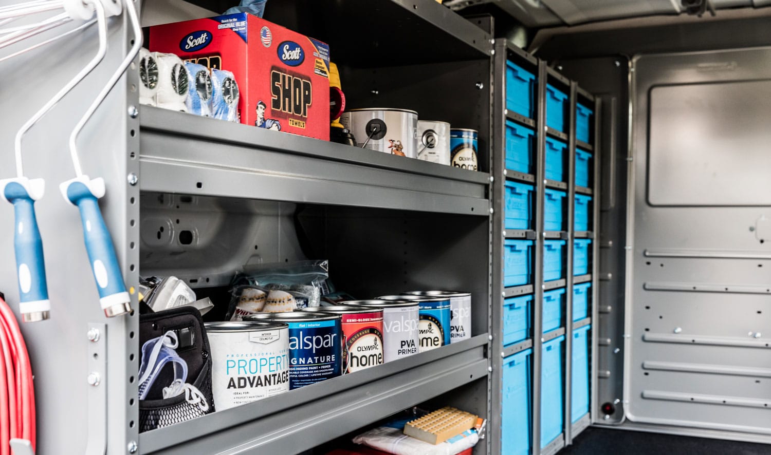 Commercial painting contractor van upfit with secure shelving, storage bins, and workspace organization for paint supplies and equipment