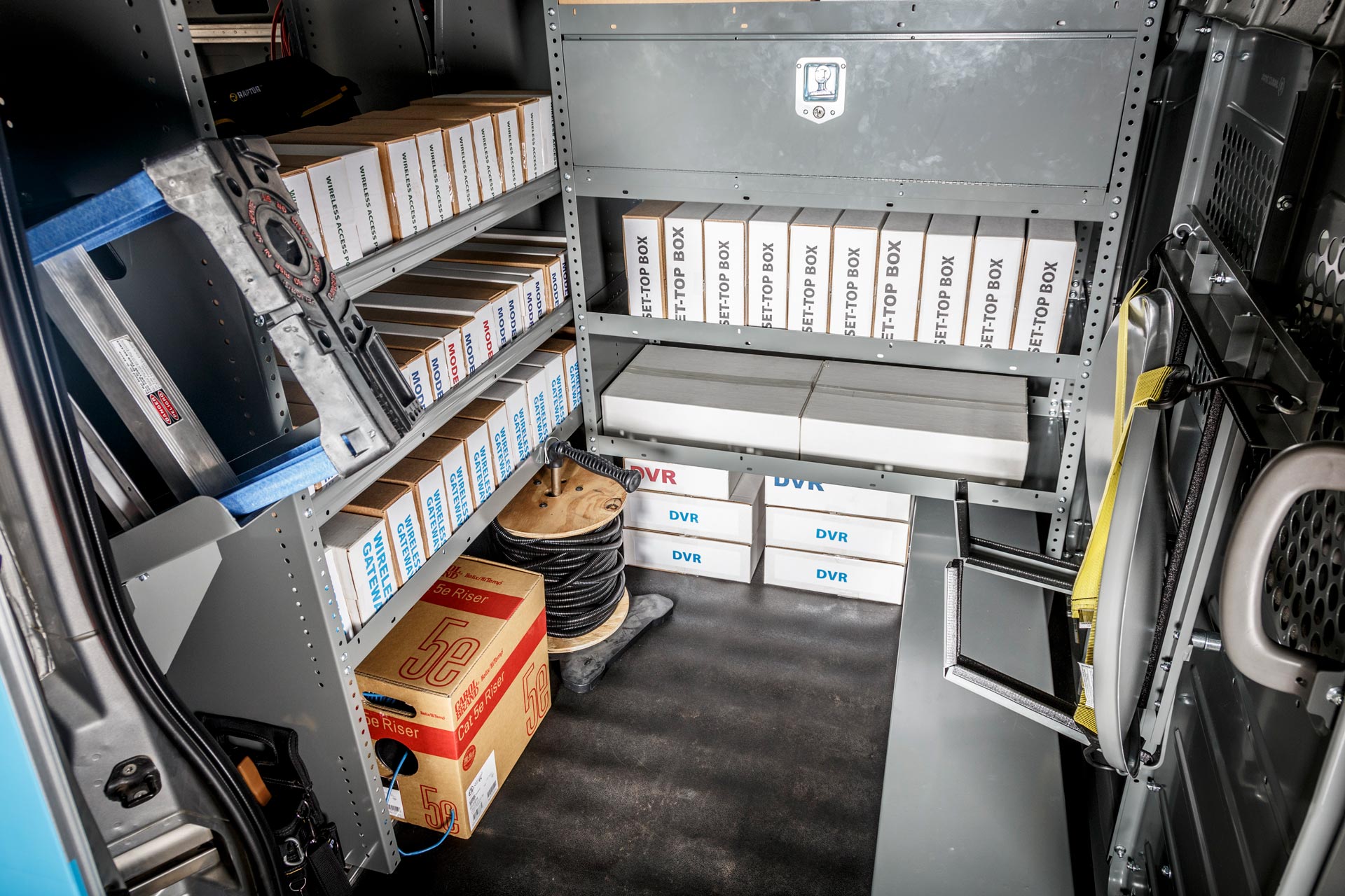 Satellite installation service van upfit with organized shelving, ladder storage, and equipment compartments for field technicians and network installers
